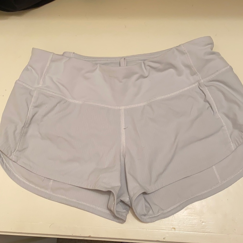 Size 2 lululemon shorts.Originally white but slightly tinted blue.Good condition